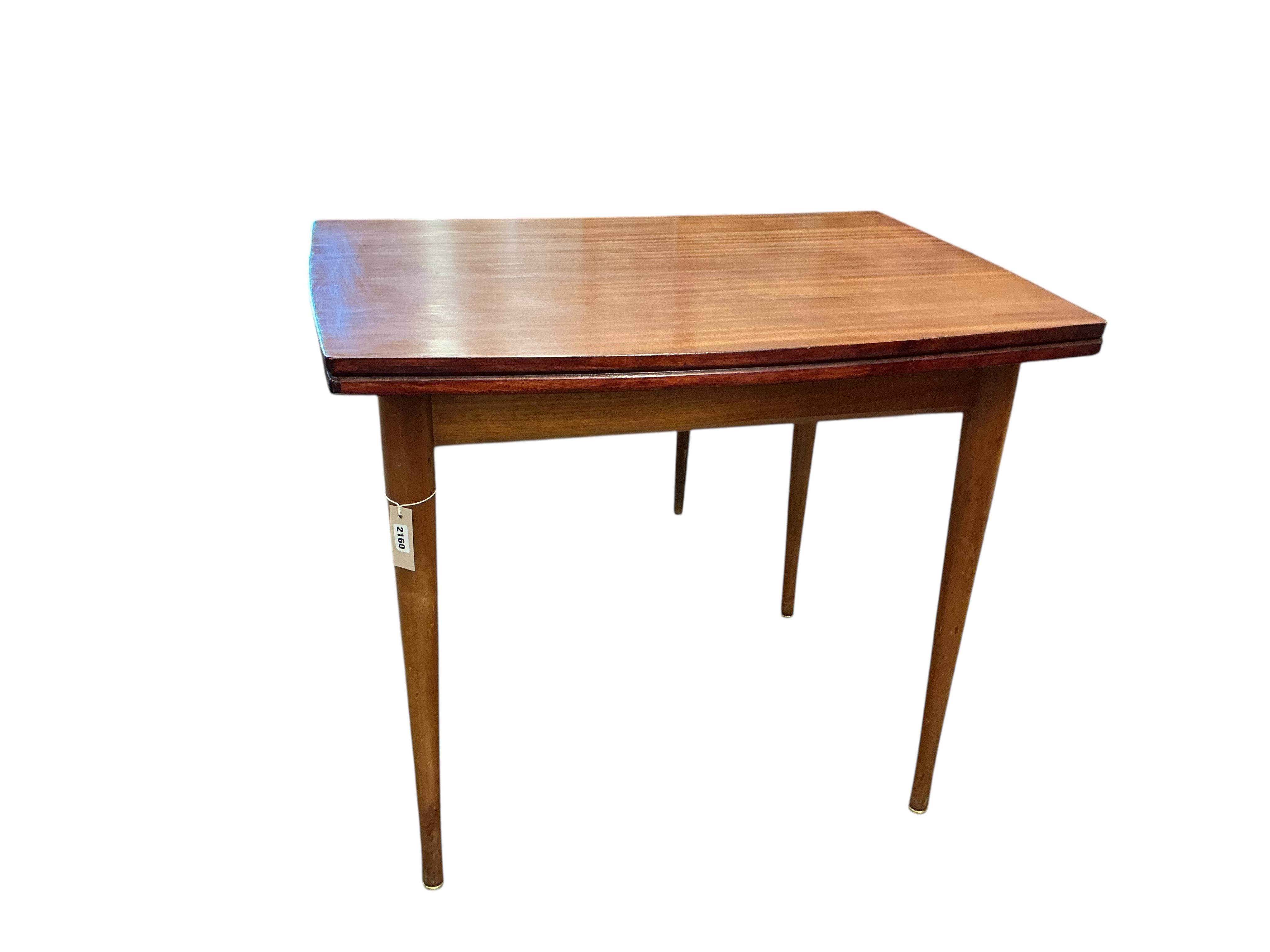 A mid century Younger teak folding, extending dining table, width 70cm, depth 90cm, height 76cm